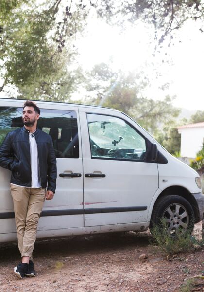 man-leaning-front-car