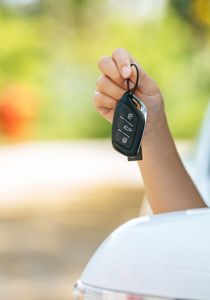 girl-sitting-car-holding-car-keys-hands-out-car